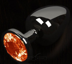 Графитовая анальная пробка с оранжевым кристаллом - 6 см.